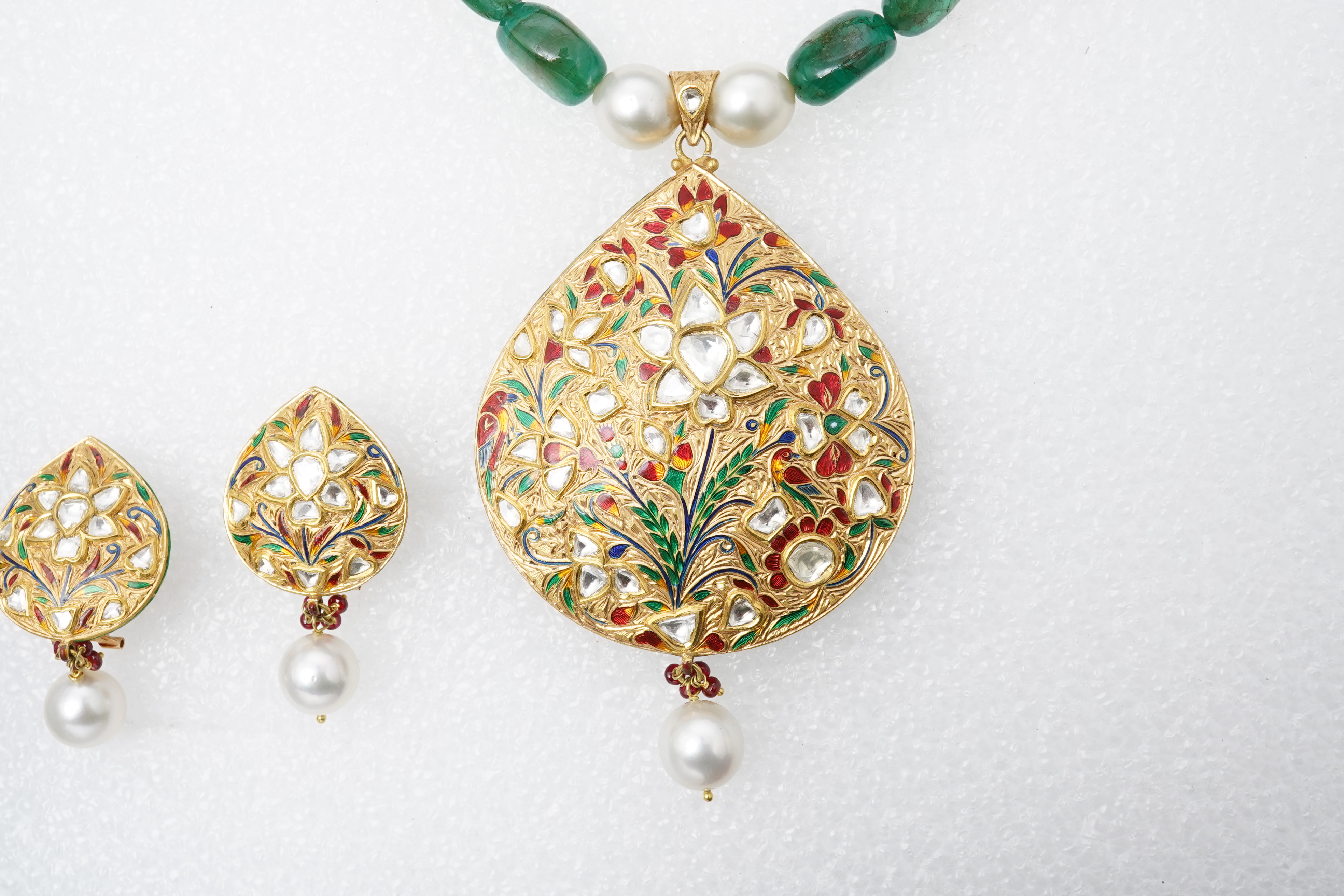 An emerald, ruby, enamel, cultured pearl and diamond demi-parure, India